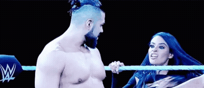 A Man And A Woman Are Wrestling In A Ring . GIF