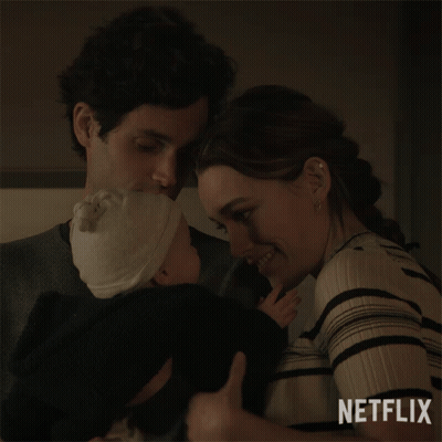 A Man And A Woman Holding A Baby With Netflix Written On The Bottom GIF