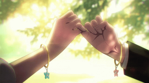 A Man And A Woman Holding Hands With Bracelets On GIF