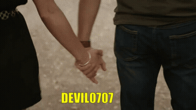 A Man And A Woman Holding Hands With The Devil0707 Written In Yellow GIF