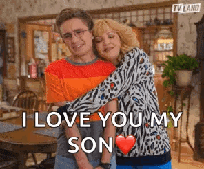 A Man And A Woman Hugging Each Other With The Words `` I Love You My Son '' Written On The Bottom . GIF