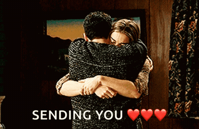A Man And A Woman Hugging Each Other With The Words `` Sending You '' Written Above Them . GIF