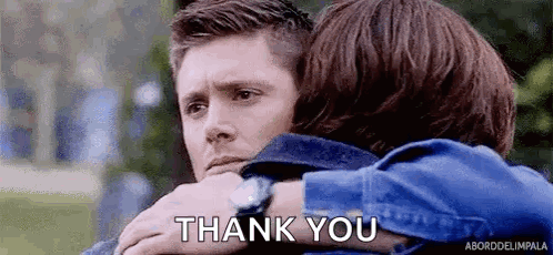A Man And A Woman Hugging Each Other With The Words `` Thank You '' Written On The Bottom . GIF