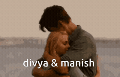 A Man And A Woman Hugging With The Words Divya & Manish Below Them GIF