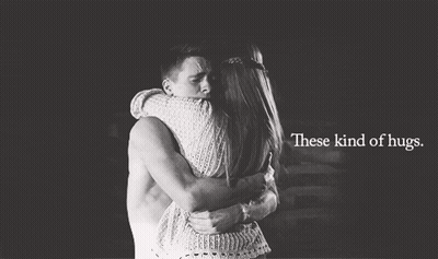 A Man And A Woman Hugging With The Words These Kind Of Hugs GIF