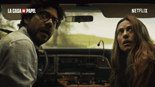 A Man And A Woman In A Car With La Casa De Papel Written On The Top GIF