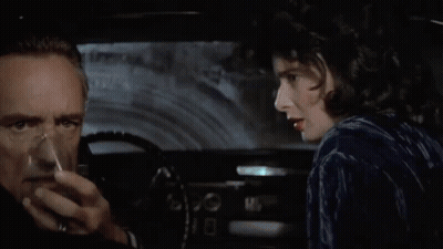 A Man And A Woman In A Car With The Words " Stay Alive Baby " Above Them GIF