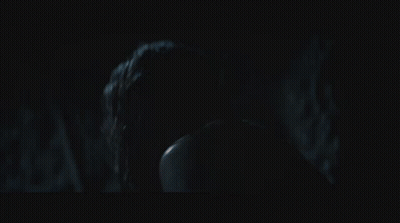A Man And A Woman In A Dark Room GIF