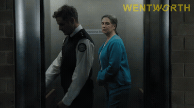 A Man And A Woman In An Elevator With The Word Wentworth On The Top GIF