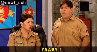 A Man And A Woman In Police Uniforms Are Standing Next To Each Other In A Room With The Words Yaaay Written Above Them GIF