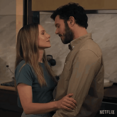 A Man And A Woman Kissing In A Kitchen With Netflix Written On The Bottom GIF