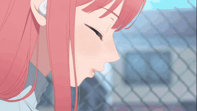 A Man And A Woman Kissing In Front Of A Fence GIF