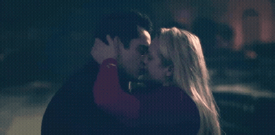 A Man And A Woman Kissing In The Dark GIF