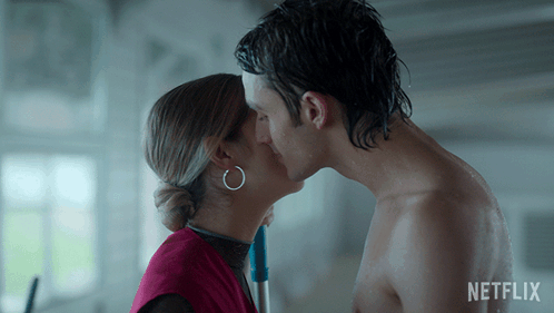 A Man And A Woman Kissing With A Netflix Logo In The Background GIF