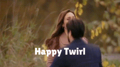 A Man And A Woman Kissing With The Words Happy Twirl Written On The Bottom GIF