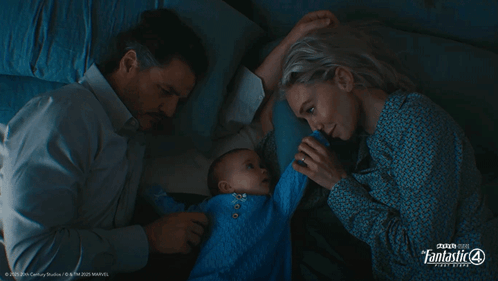 A Man And A Woman Laying Next To A Baby With Fantastic 4 Written On The Bottom Left GIF