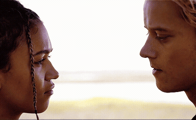 A Man And A Woman Look At Each Other With Their Eyes Closed GIF