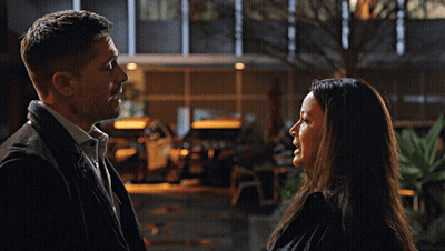 A Man And A Woman Looking At Each Other GIF