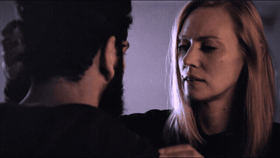A Man And A Woman Looking At Each Other GIF