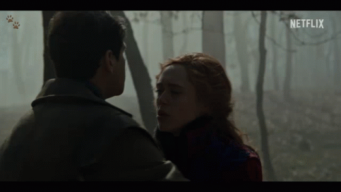 A Man And A Woman Looking At Each Other With A Netflix Logo In The Corner GIF
