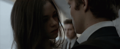 A Man And A Woman Looking Into Each Other 'S Eyes GIF
