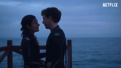 A Man And A Woman Looking Into Each Other 'S Eyes With A Netflix Logo In The Corner GIF
