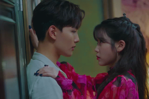 A Man And A Woman Looking Into Each Others Eyes GIF