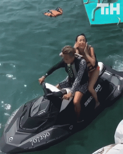 A Man And A Woman On A Jet Ski With The Number 707290 GIF