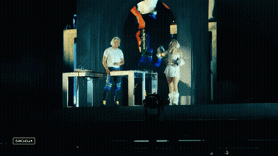A Man And A Woman On A Stage With The Word Cancella In The Lower Right Corner GIF