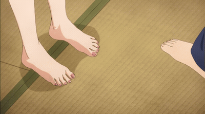 A Man And A Woman 'S Bare Feet Are Standing On A Mat GIF