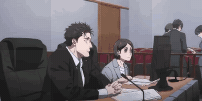 A Man And A Woman Sit At A Desk In Front Of A Computer GIF