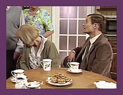 A Man And A Woman Sit At A Table With Cups And Saucers Of Tea GIF