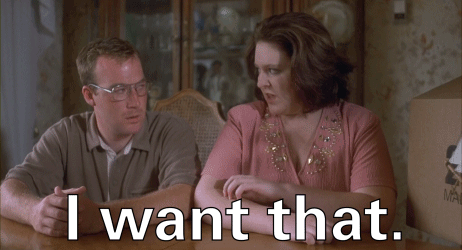 A Man And A Woman Sit At A Table With The Words I Want That GIF