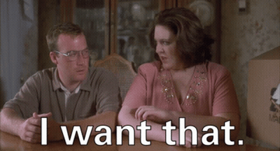 A Man And A Woman Sit At A Table With The Words I Want That GIF
