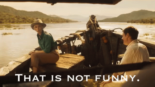 A Man And A Woman Sit In A Boat With The Words That Is Not Funny Below Them GIF
