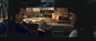A Man And A Woman Sit In A Car Talking GIF