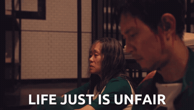 A Man And A Woman Sit Next To Each Other With The Words Life Just Is Unfair GIF