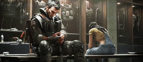 A Man And A Woman Sit On A Bench In A Locker Room . GIF