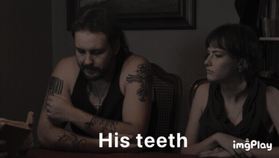 A Man And A Woman Sitting At A Table With The Words His Teeth On The Bottom GIF