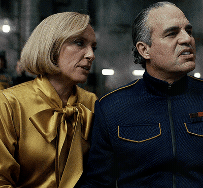 A Man And A Woman Sitting Next To Each Other GIF