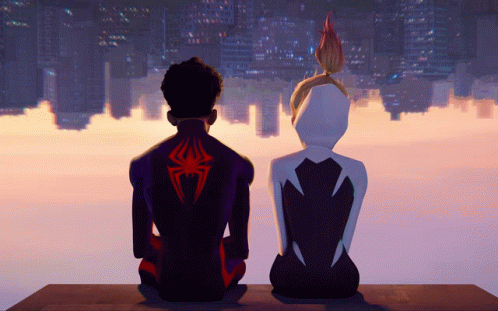 A Man And A Woman Sitting Next To Each Other With A Spider On Their Back GIF