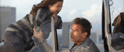 A Man And A Woman Standing Next To Each Other GIF