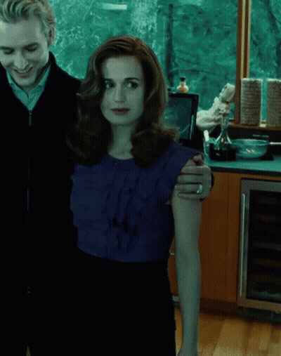 A Man And A Woman Standing Next To Each Other GIF