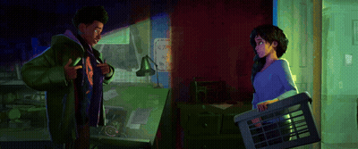 A Man And A Woman Standing Next To Each Other In A Room GIF