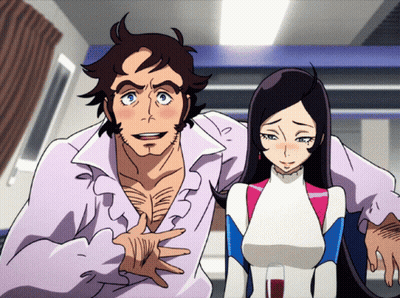 A Man And A Woman Standing Next To Each Other In A Room GIF