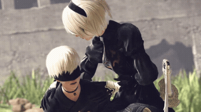 A Man And A Woman Standing Next To Each Other GIF