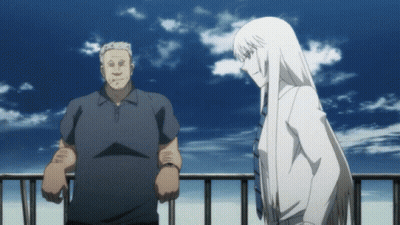A Man And A Woman Standing Next To Each Other On A Balcony GIF