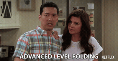 A Man And A Woman Standing Next To Each Other With Advanced Level Folding Netflix Written On The Bottom Right GIF