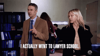 A Man And A Woman Standing Next To Each Other With The Man Saying I Actually Went To Lawyer School GIF