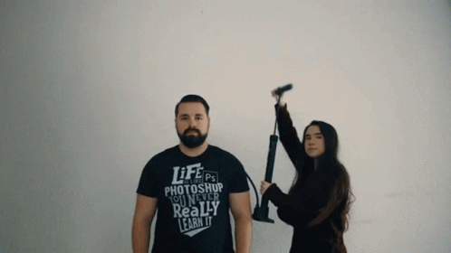 A Man And A Woman Standing Next To Each Other With The Man Wearing A Shirt That Says Life Photoshop You Never Really Lea GIF